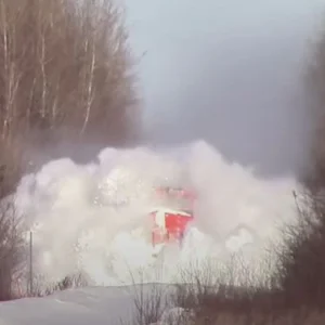 Train barrels towards wall of snow and creates phenomenal sight when it crashes into it