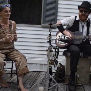 Calm Woman Plays Music with Spoons, Lounging on Her Front Porch