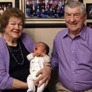 Husband and wife, married for 59 years, greet their 100th grandchild. Four generations together under one roof. Their family photo will astound you.