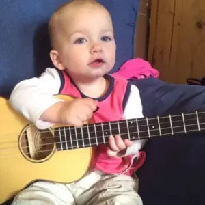 This baby is only one year old and plays the guitar